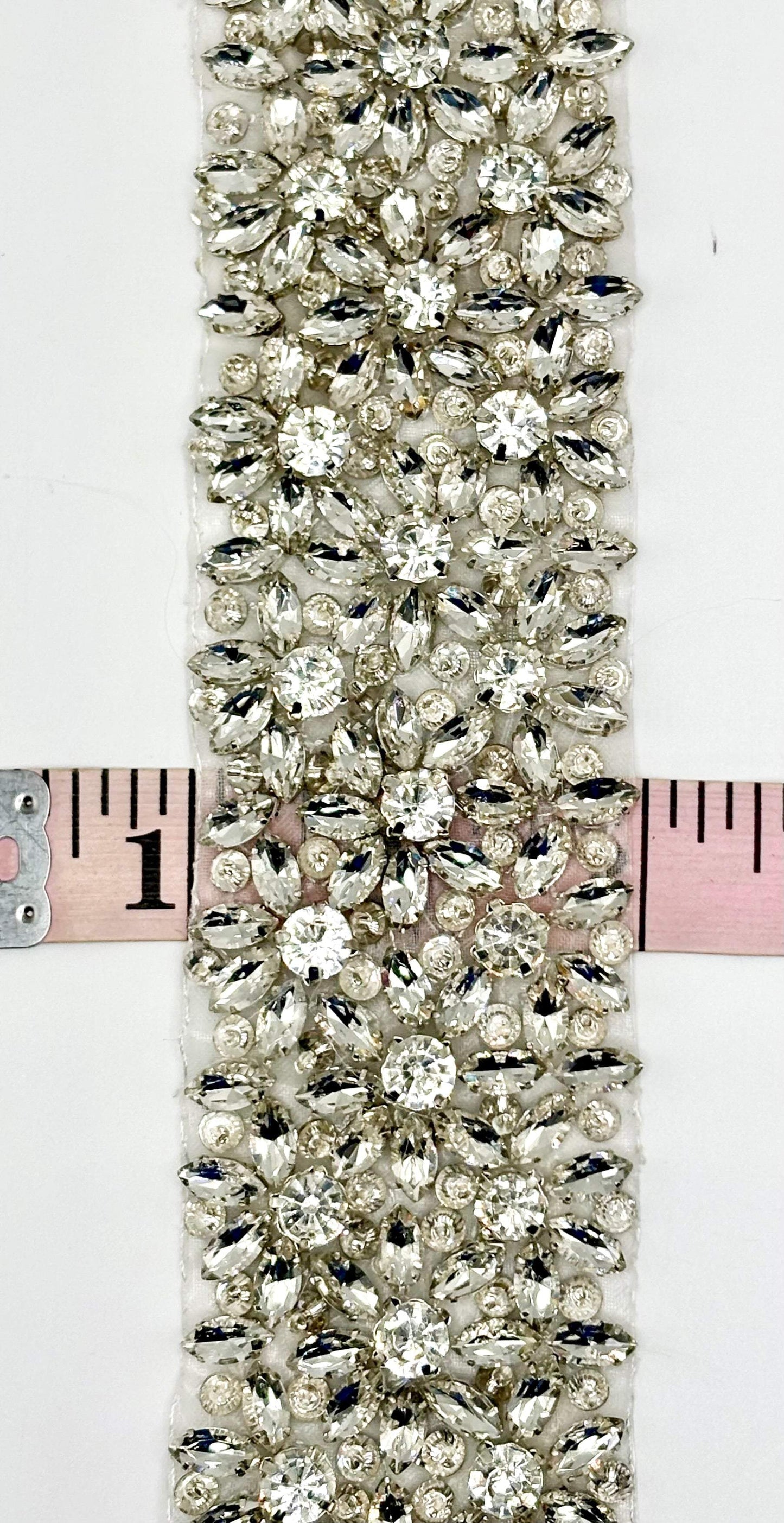 Ariel Rhinestone trim with silver setting and intricate design, 2 inches wide.