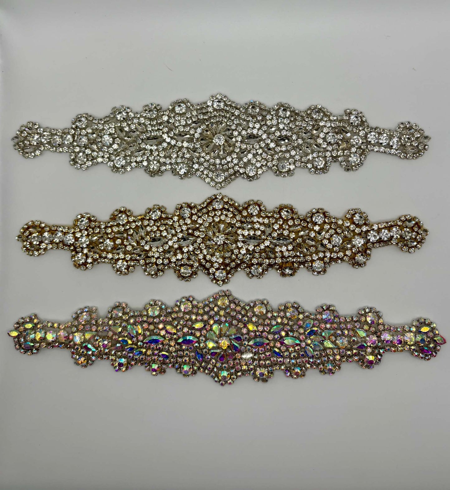 Handmade rhinestone bridal belts in silver, gold, and multicolor designs.
