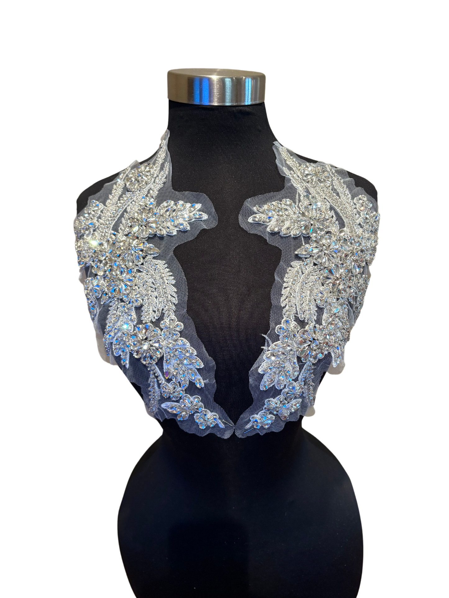 Handmade rhinestone applique pair in vibrant color on mannequin.
