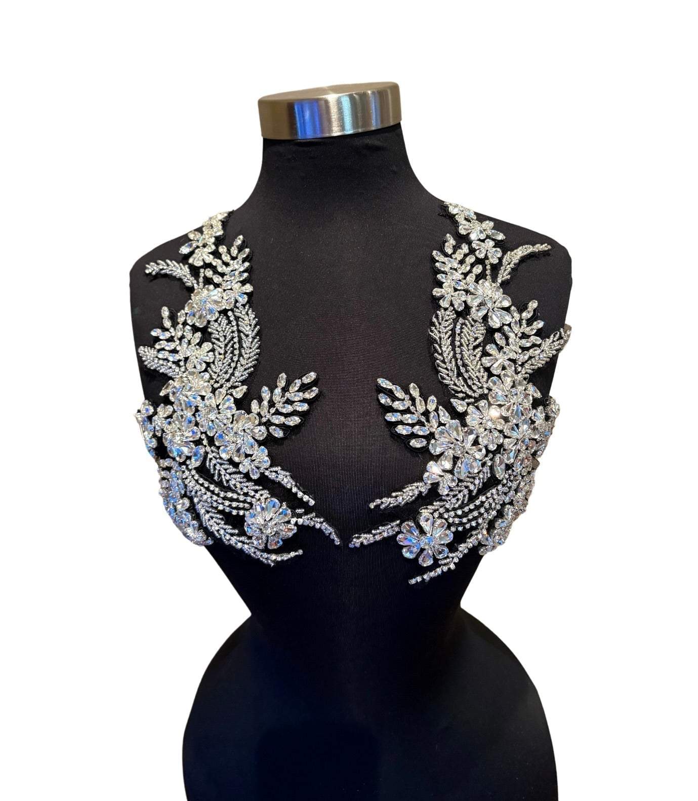 Handmade rhinestone applique pair in vibrant color on mannequin.
