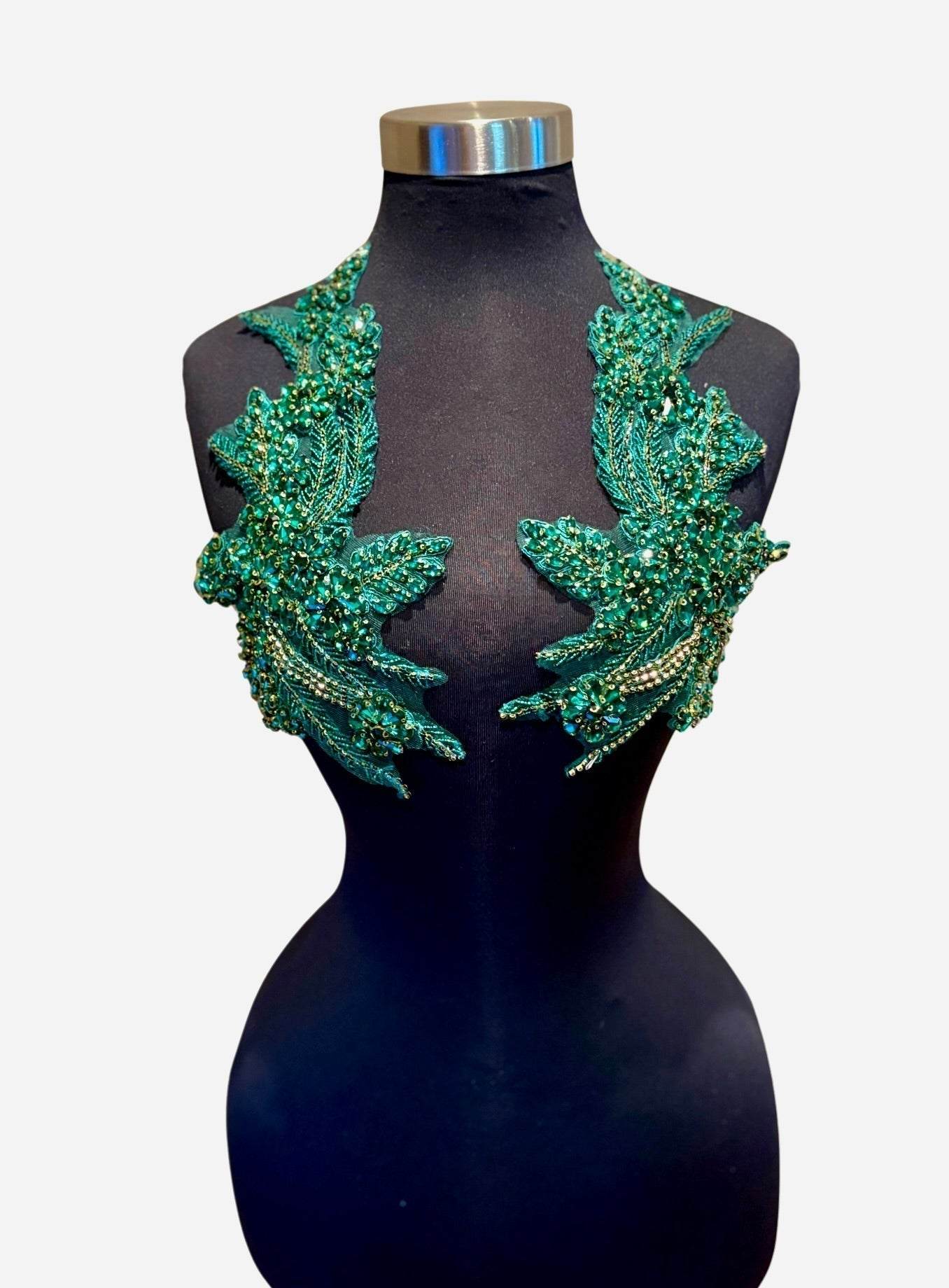 Handmade rhinestone applique pair in vibrant color on mannequin.