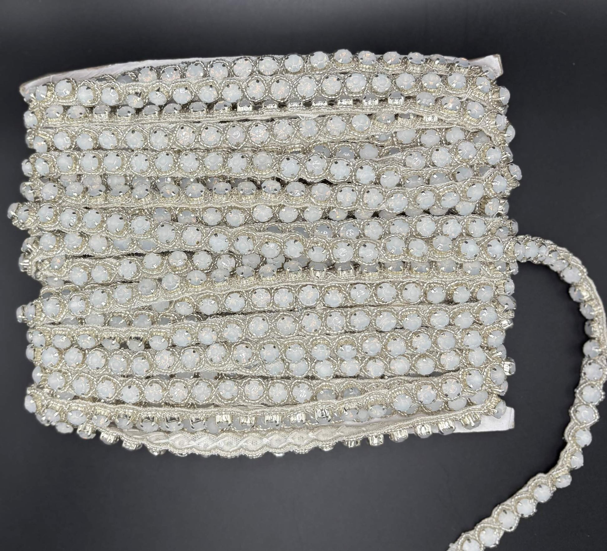Opal Elegance Yardage featuring opal stones in silver setting, 1/4" wide trim for crafts and decor.