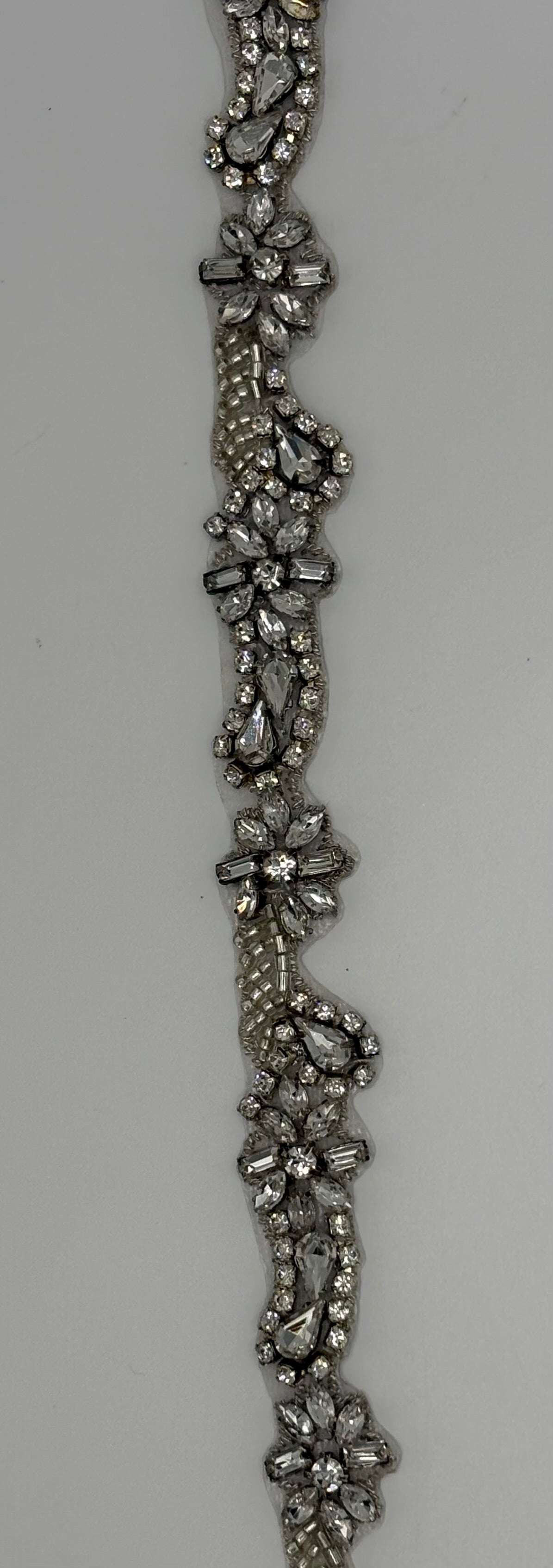 Zoey's handmade rhinestone trim with clear rhinestone silver setting, 1/2 inch width.