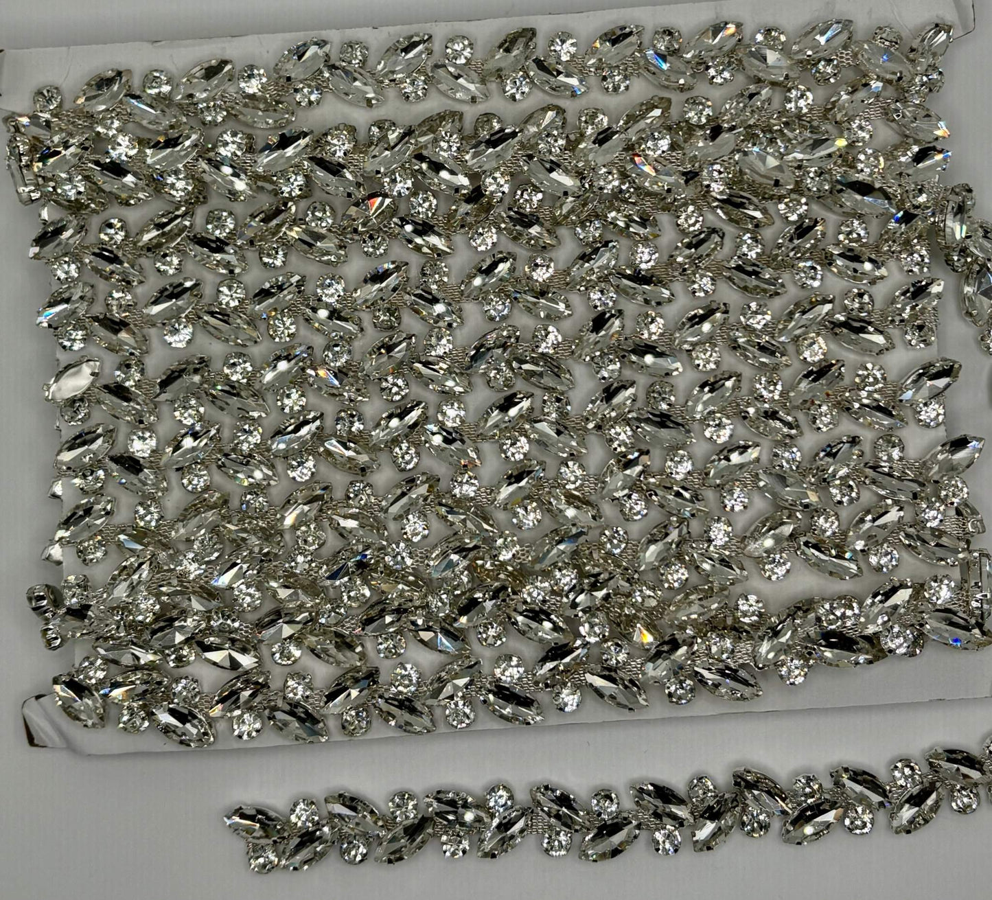 Rhinestone chain yardage with sparkling rhinestones approx. 1/4" wide for versatile embellishments.
