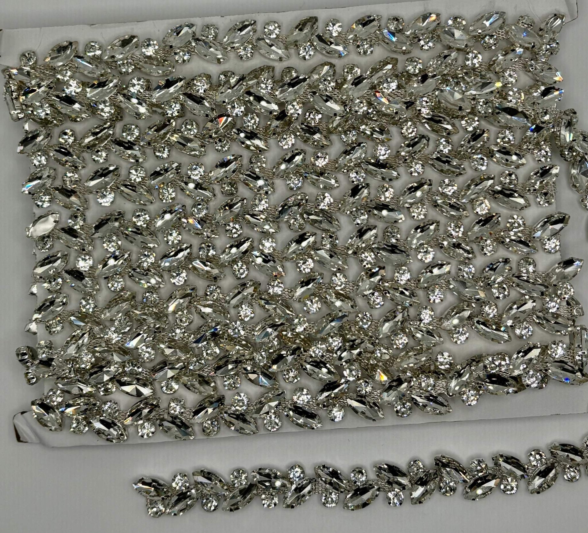 Rhinestone chain yardage with sparkling rhinestones approx. 1/4" wide for versatile embellishments.