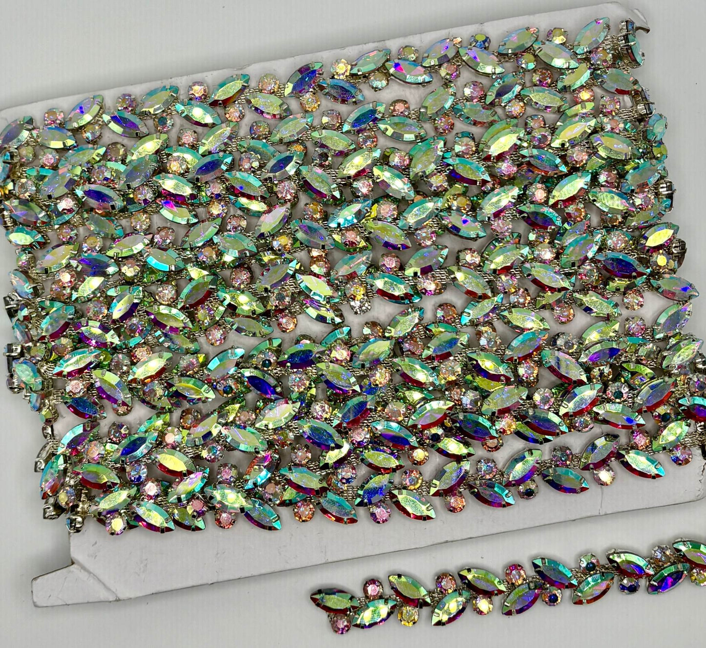 Rhinestone chain yardage with colorful sparkling stones on a card, approx. 1/4" wide.