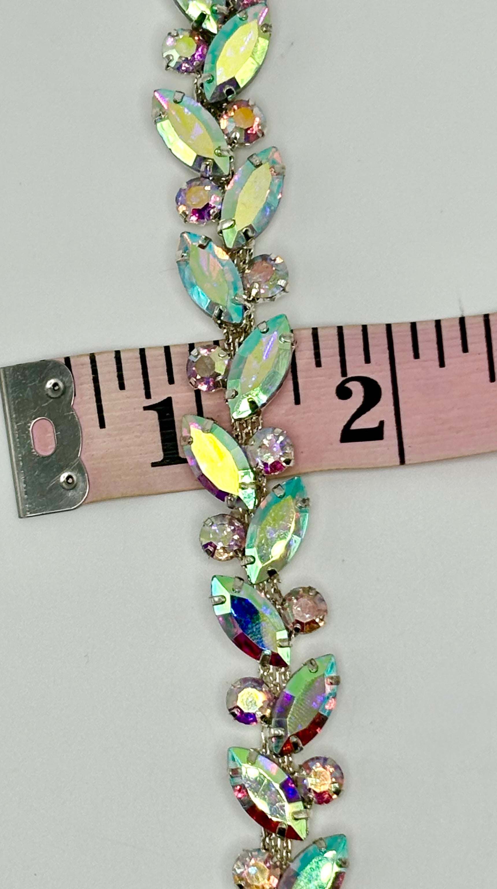 Rhinestone Chain Yardage measuring 1/4 inch wide with sparkling rhinestones on a flexible chain.