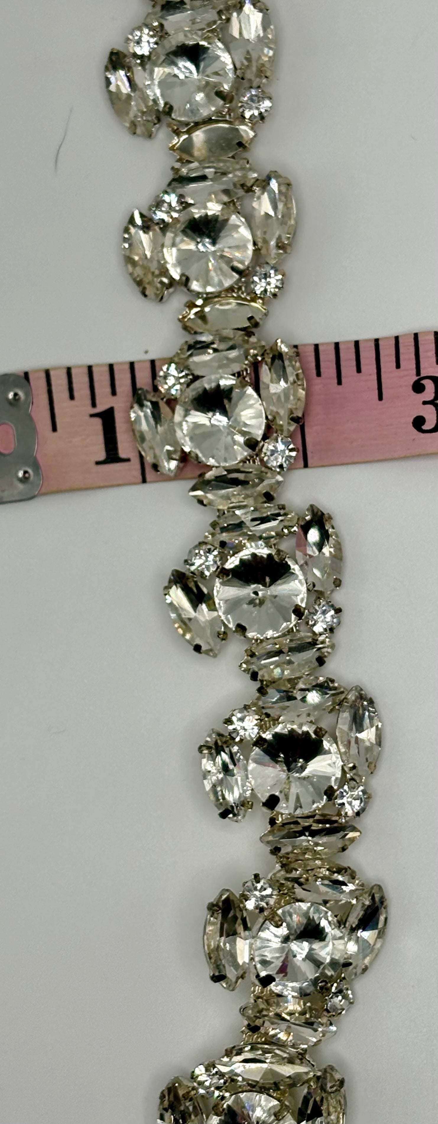 Large rhinestone cluster on chain back yardage, clear silver, 1-inch width.