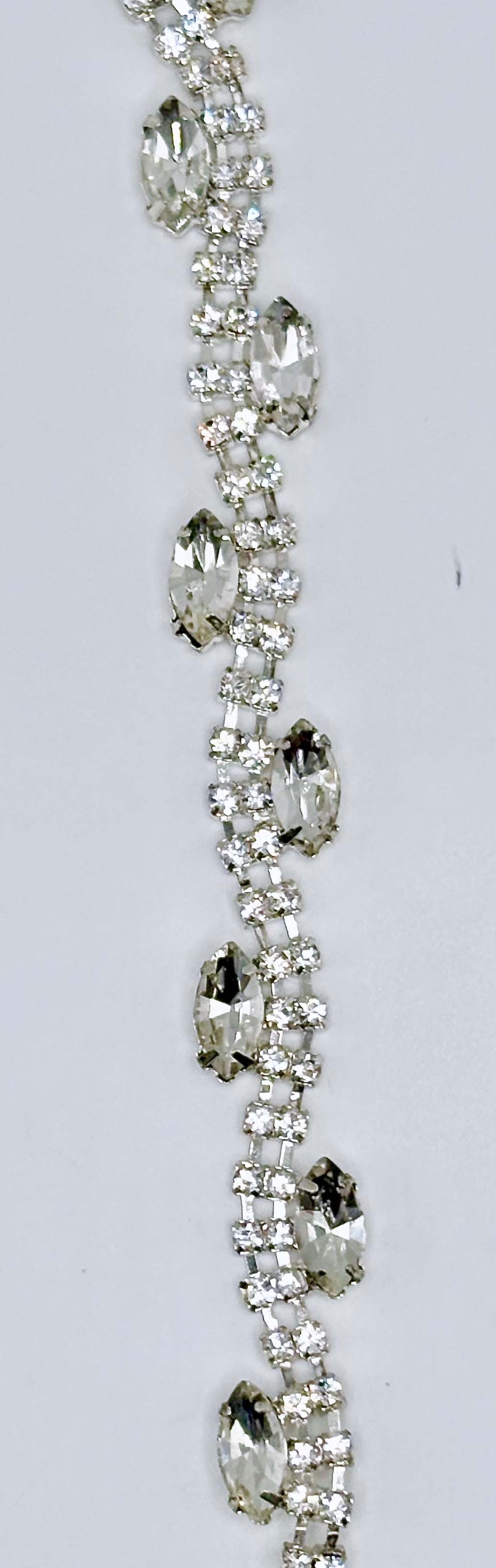 "Allison" Rhinestone Yardage with clear rhinestones on silver trim, approximately 3/8" wide.