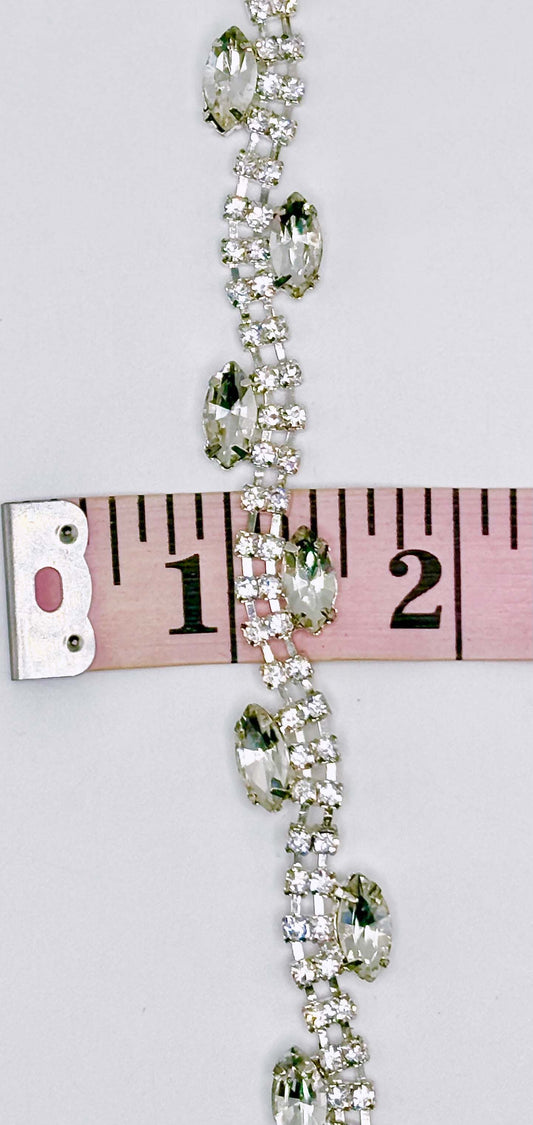 "Allison" Rhinestone Yardage with clear rhinestones on silver trim measuring approximately 3/8 inch wide.