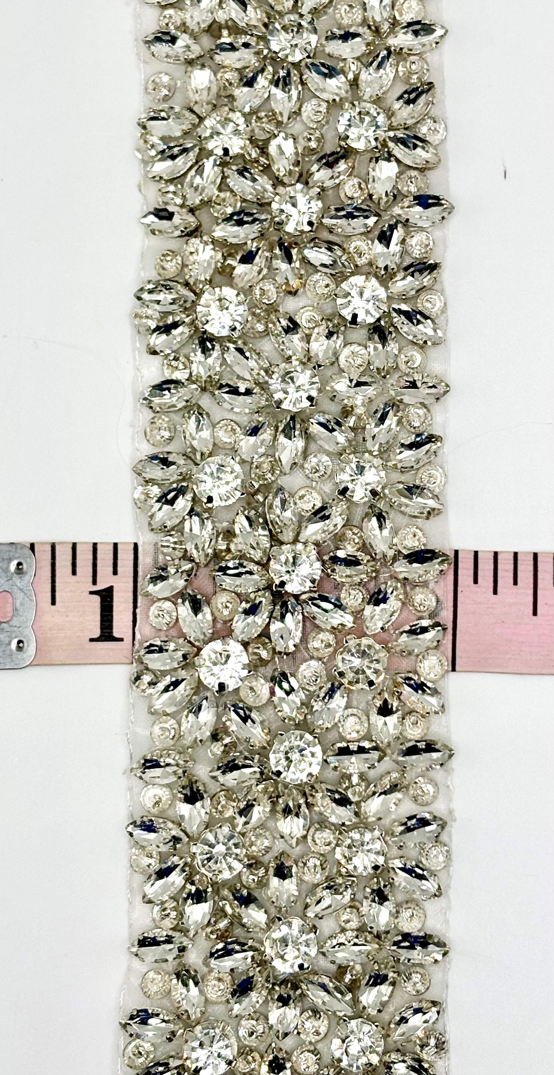 Ariel Rhinestone trim with silver setting and intricate design, 2 inches wide.