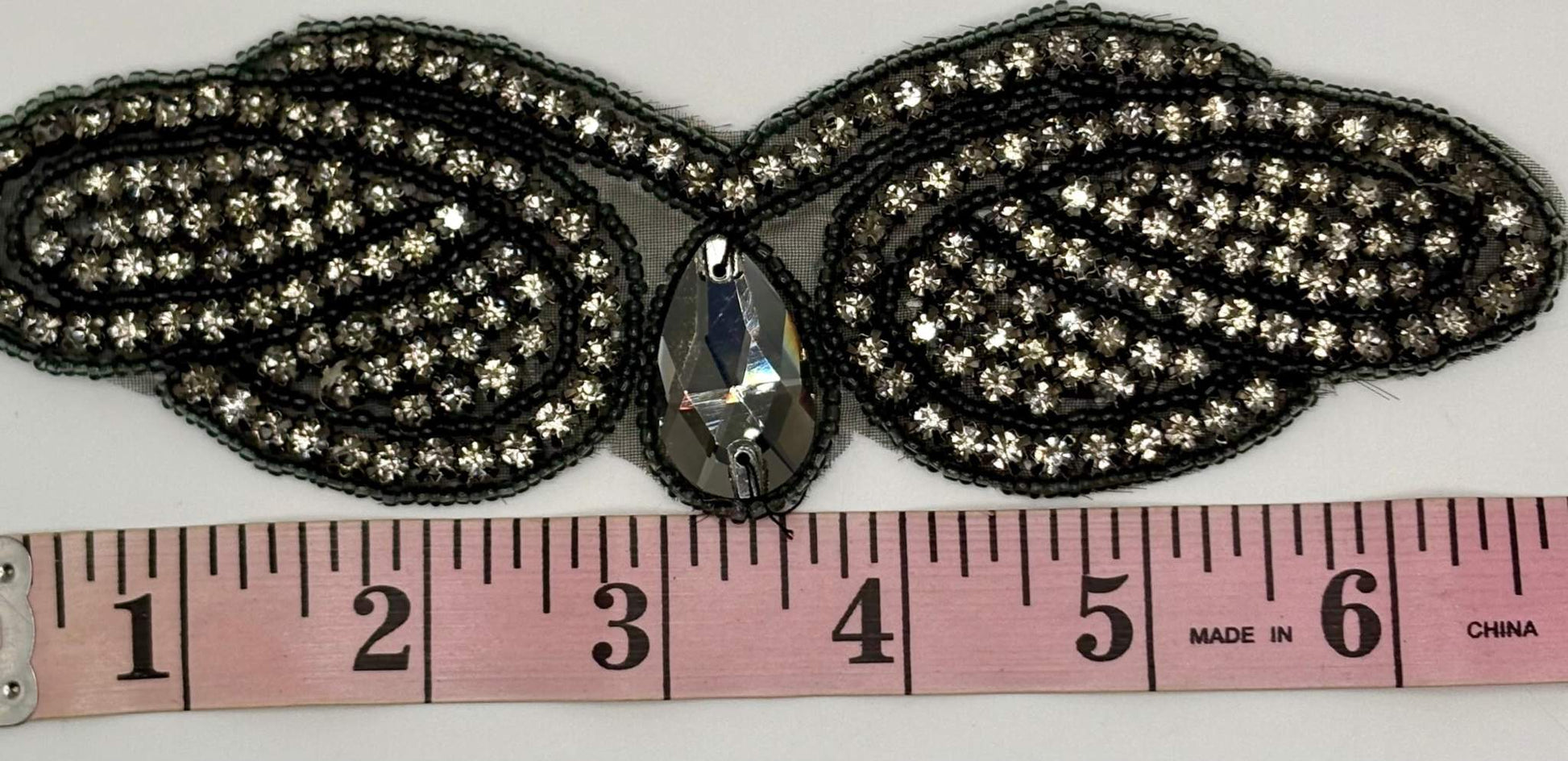 2.5" wide rhinestone romance yardage with measuring tape.