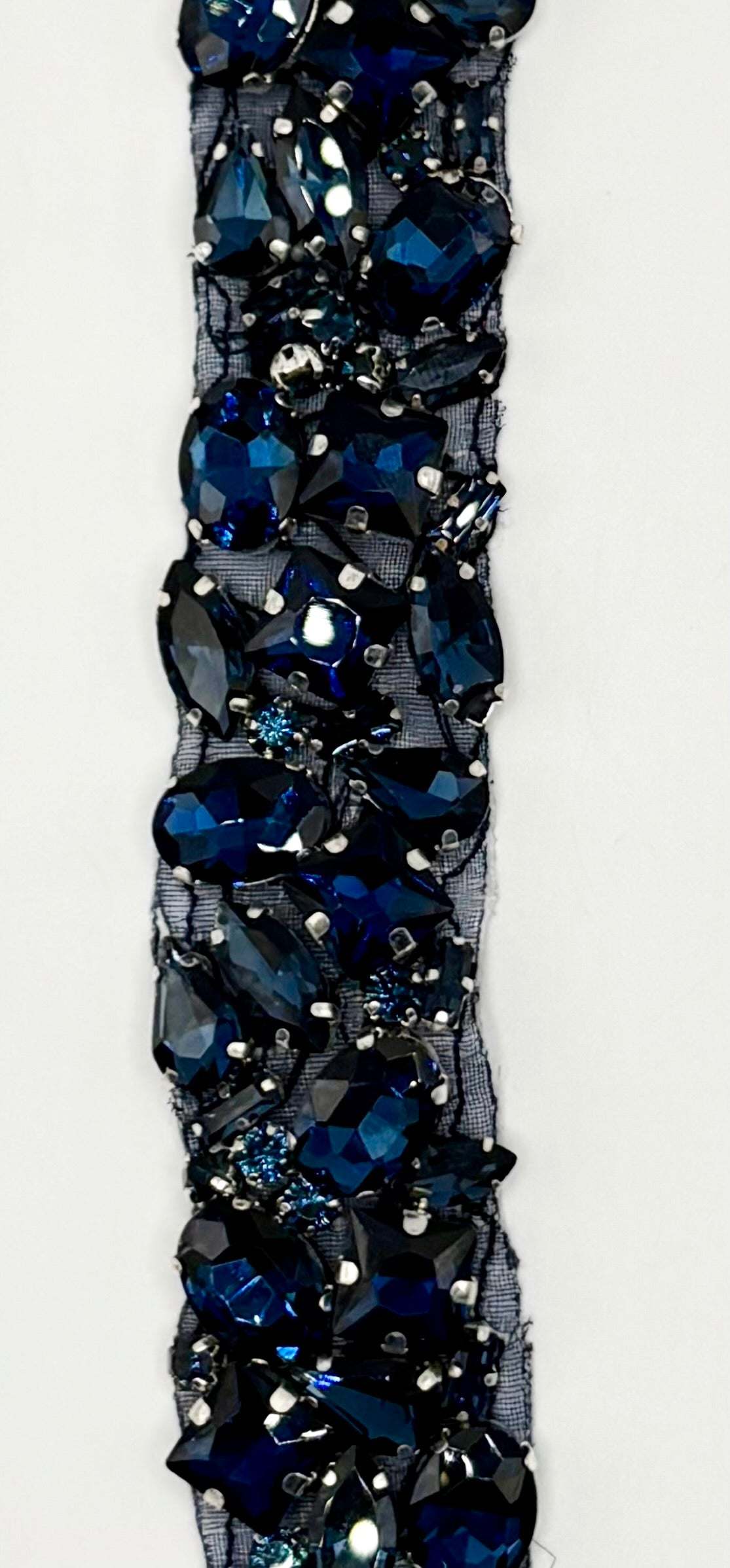 Handmade multi stone yardage featuring multi-colored rhinestones, 1 inch wide.