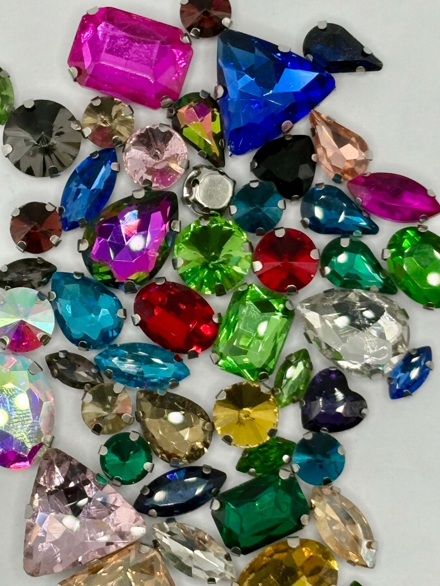 Assorted rhinestones in various sizes and vibrant colors, perfect for crafting and design projects.