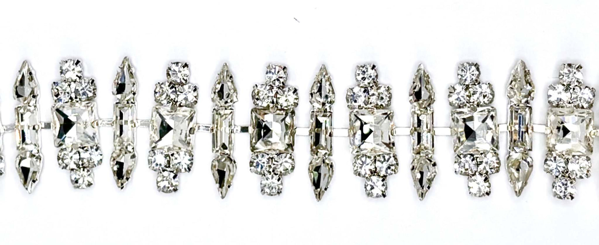 Rhinestone chain yardage with sparkling rhinestones on flexible chain, 1 inch wide.