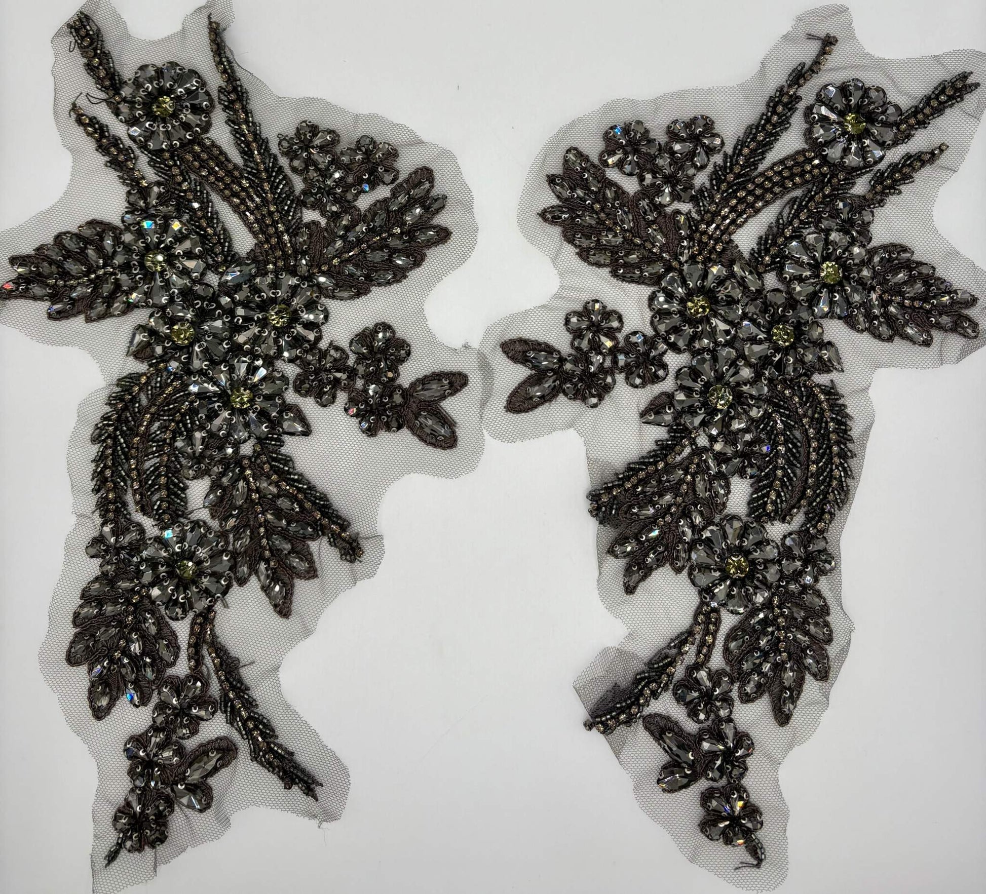 Handmade rhinestone appliqué pair in various colors, measuring 11 inches, for elegant accenting on garments.