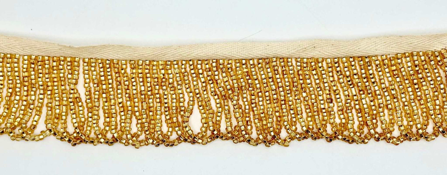 Gold Beaded Looped Fringe Trim featuring delicate glass beads in a luxurious drape, perfect for couture designs.