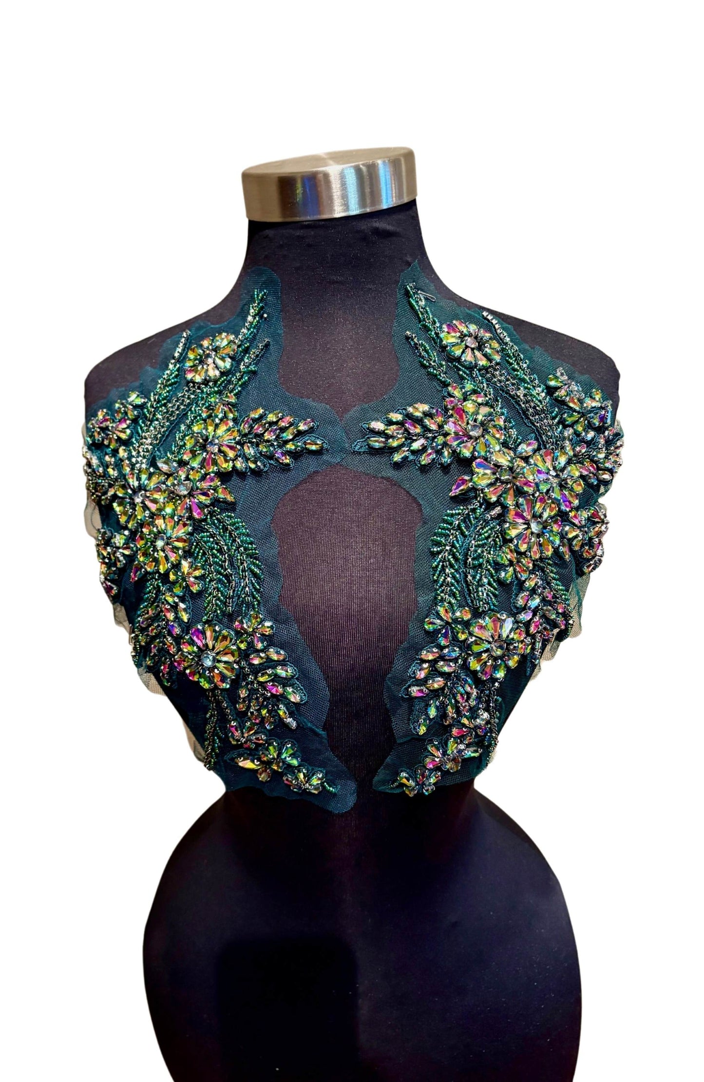Handmade rhinestone applique pair in vibrant color on mannequin.