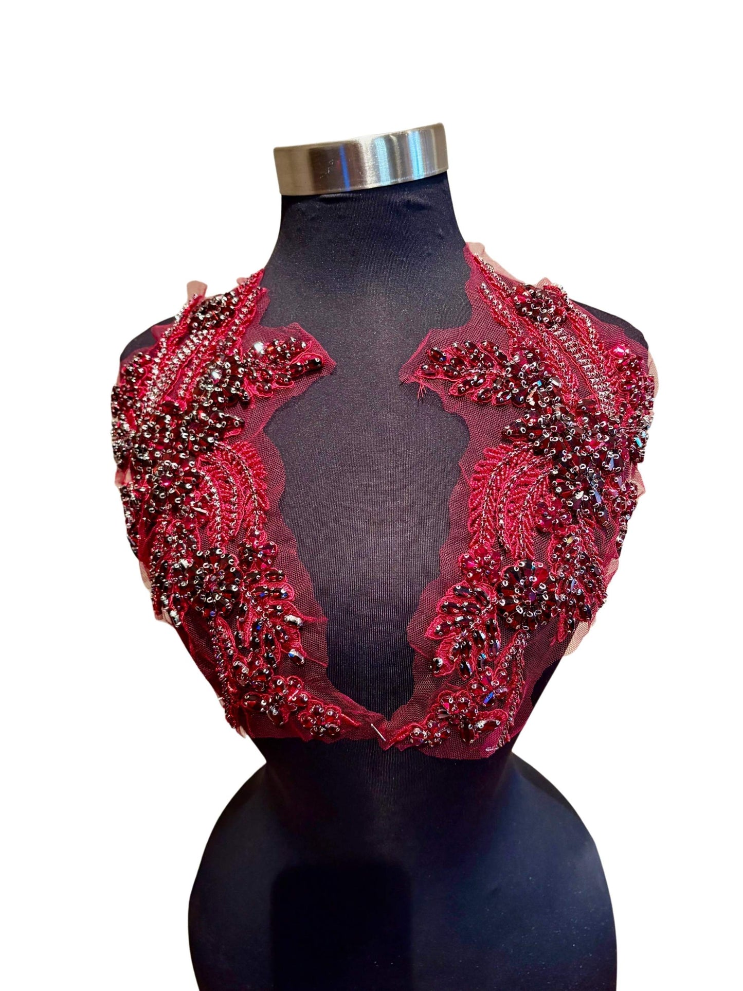 Handmade rhinestone applique pair in vibrant color on mannequin.