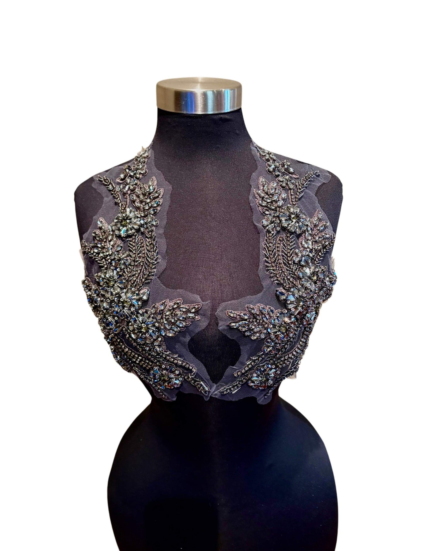 Handmade rhinestone applique pair in vibrant color on mannequin.
