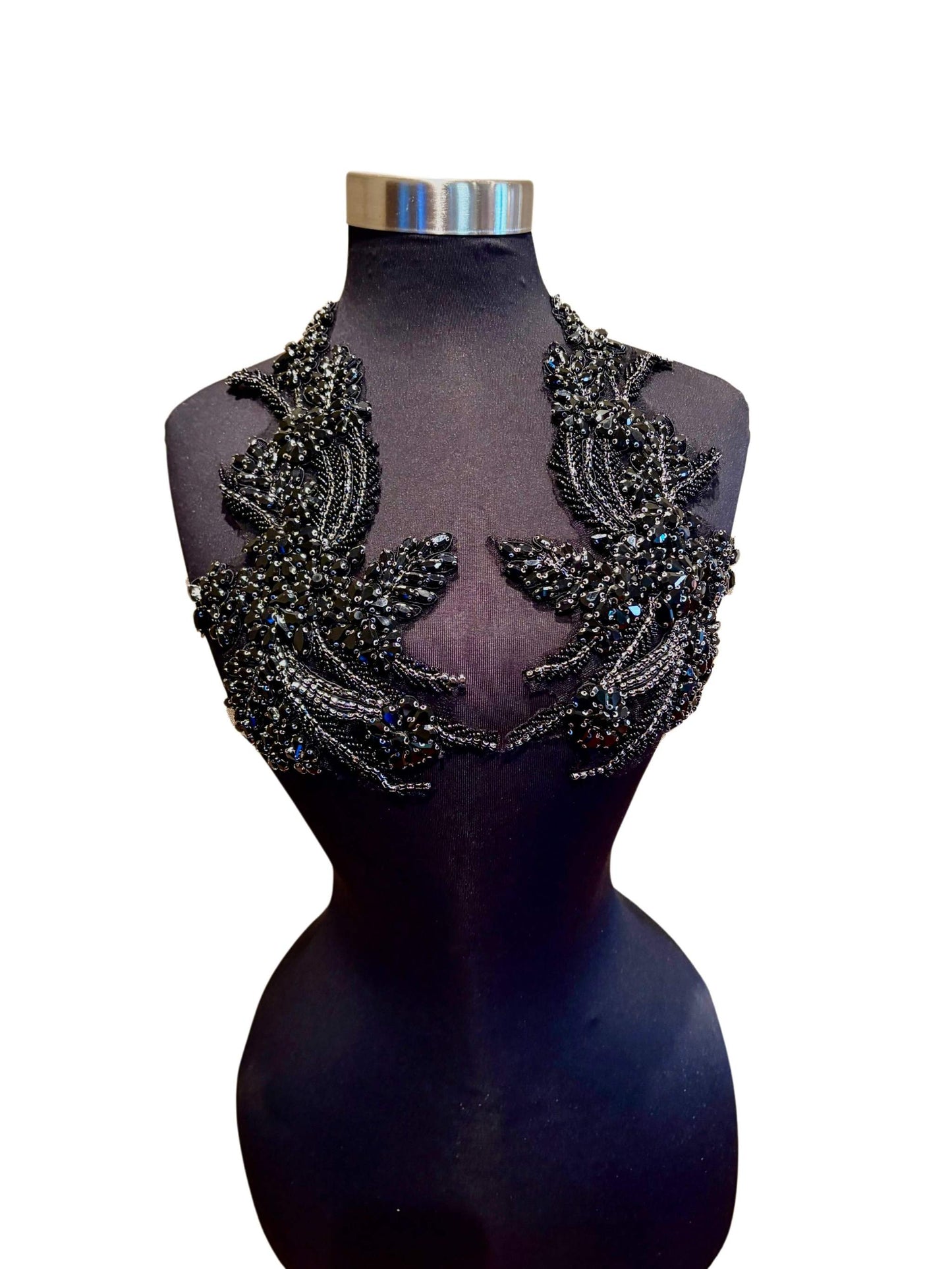 Handmade rhinestone applique pair in vibrant color on mannequin.