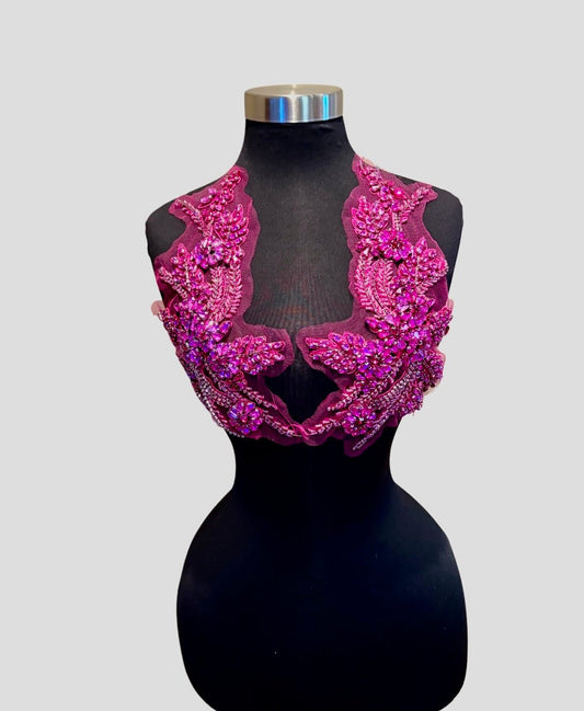 Handmade rhinestone applique pair in vibrant color on mannequin.