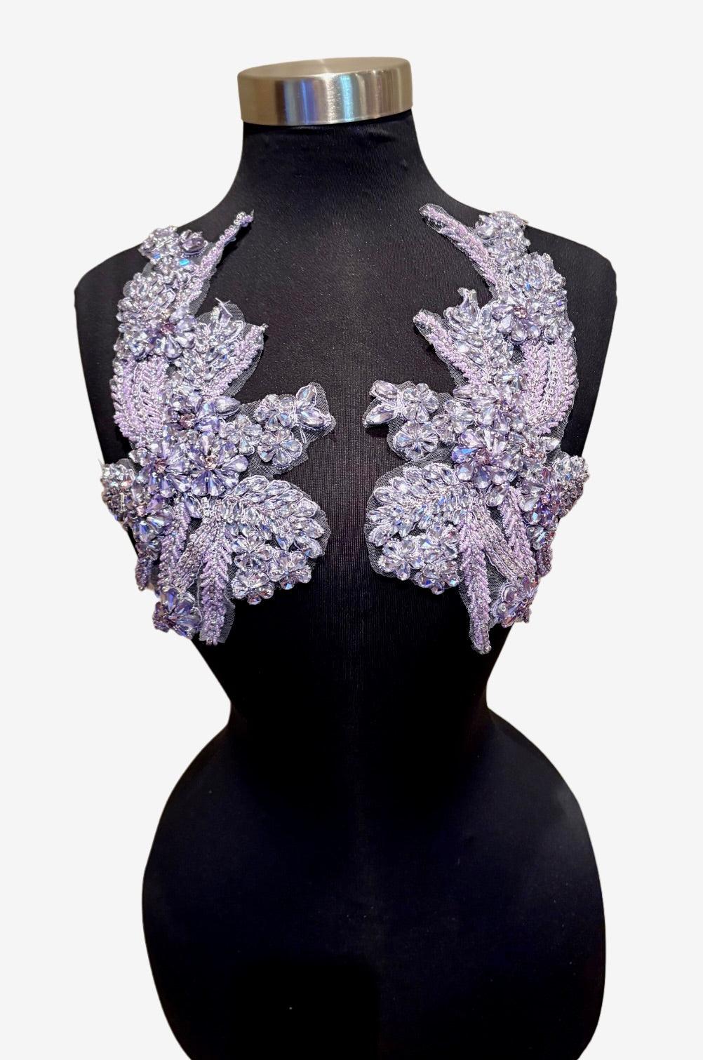 Handmade rhinestone applique pair in vibrant color on mannequin.