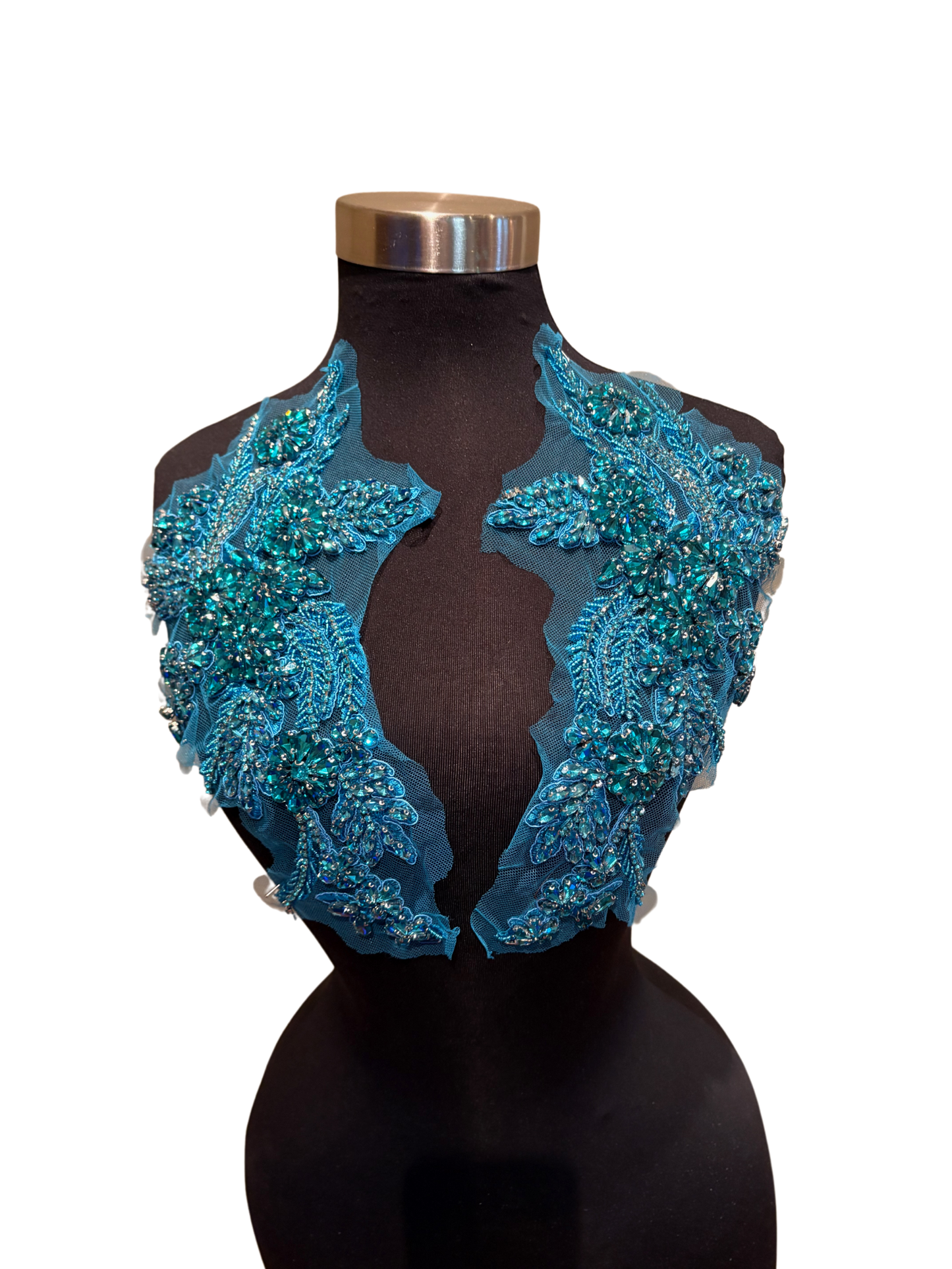 Handmade rhinestone applique pair in vibrant color on mannequin.